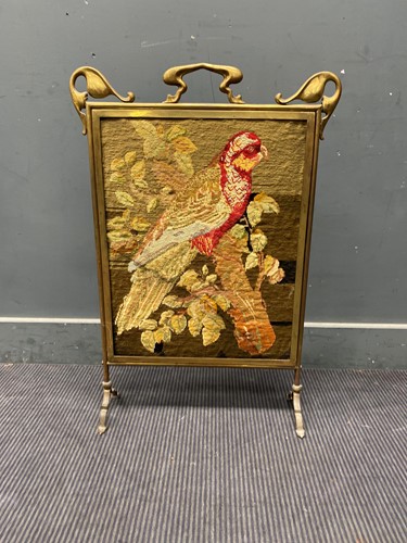 Lot 449 - An Art Nouveau brass fireguard with tapestry...