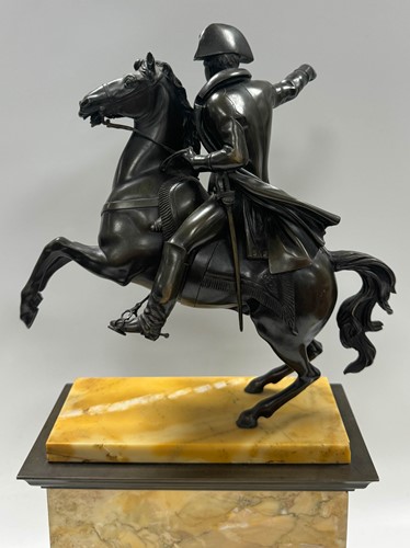 Lot 515 - A patinated bronze model of Napoleon on horseback, late 19th century