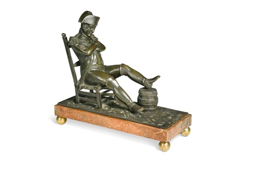 Lot 529 - A bronze model of the recumbent Napoleon resting his foot on a barrel, French School, 19th century