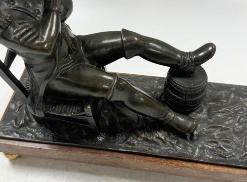 Lot 529 - A bronze model of the recumbent Napoleon resting his foot on a barrel, French School, 19th century