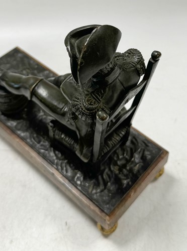 Lot 529 - A bronze model of the recumbent Napoleon resting his foot on a barrel, French School, 19th century