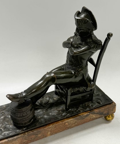 Lot 529 - A bronze model of the recumbent Napoleon resting his foot on a barrel, French School, 19th century