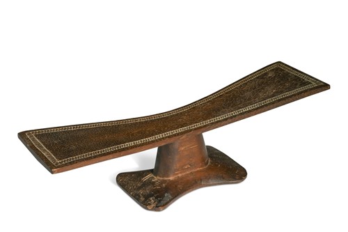 Lot 449 - A carved wood headrest, probably African, late 19th or early 20th century