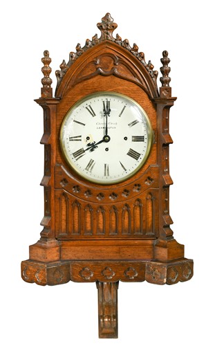 Lot 473 - A Victorian oak Gothic case chiming clock and wall bracket