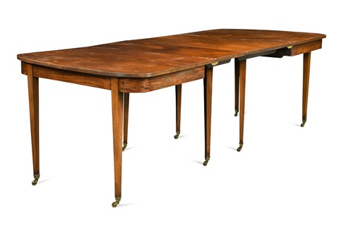 Lot 438 - A late George III mahogany D end dining table