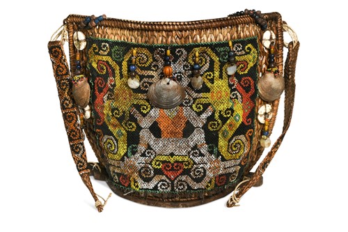 Lot 452 - An unusual Dayak beadwork decorated baby carrier, from Borneo, 20th century