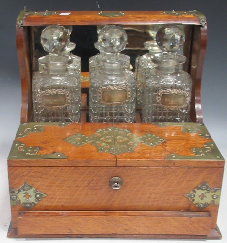 Lot 196 - A brass bound oak three bottle tantalus