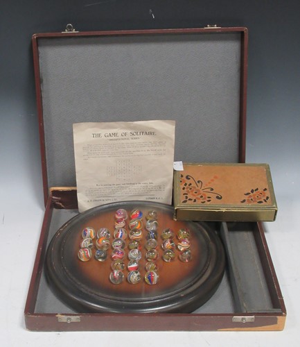 Lot 248 - A wooden solitaire board with coloured glass...