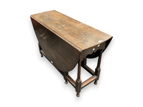 Lot 435 - A stained oak gate-leg table, 72 x 112 x 42cm...