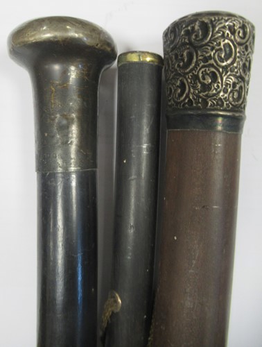 Lot 188 - Three walking canes with precious metal tops