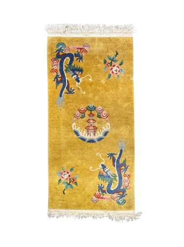Lot 877 - A Chinese wool rug, yellow ground decorated...
