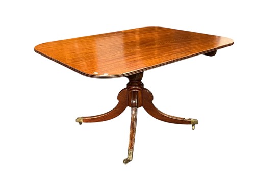 Lot 702 - A Regency mahogany tilt top table, on turned...