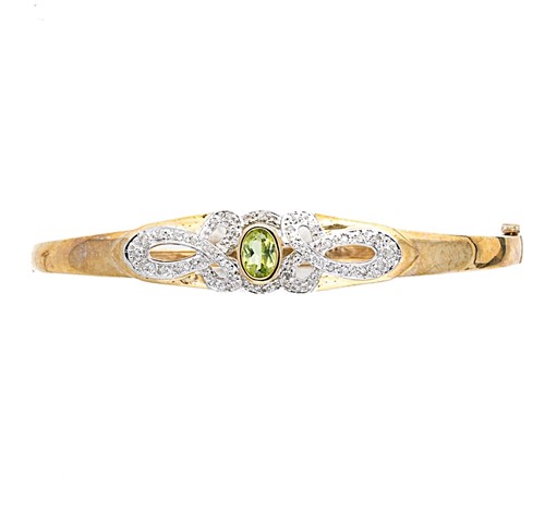 Lot 2 - A 9ct gold peridot and diamond bangle