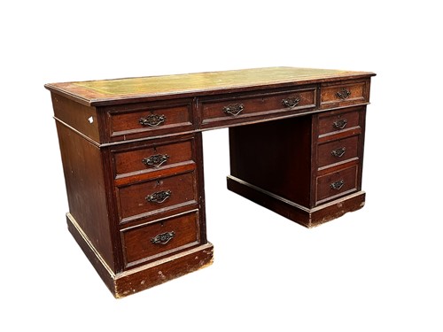 Lot 442 - An Edwardian pedestal desk, green inset...