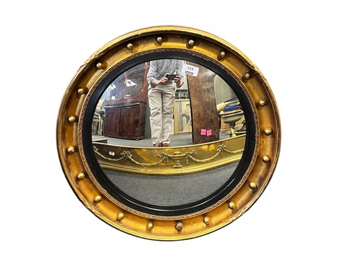 Lot 633 - A Regency style gilt convex mirror, with ball...