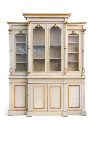 Lot 465 - A Neoclassical style grey painted parcel gilt breakfront bookcase, 20th century