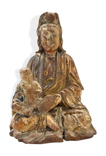 Lot 127 - A Chinese carved and gilded wood figure of Guanyin with child, late Ming/early Qing Dynasty