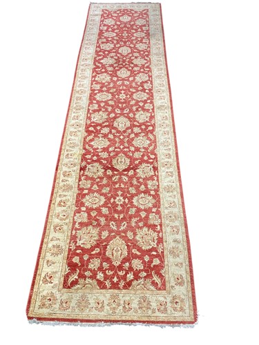 Lot 735 - A Ziegler design runner, the red field filled...