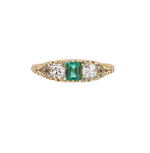 Lot 77 - An emerald and diamond carved half hoop style ring