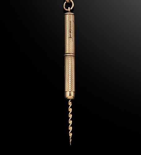 Lot 237 - A 20th century 9ct gold cigar piercer with accompanying chain