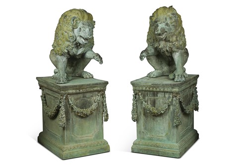 Lot 705 - A pair of verdigris patinated bronze garden lions on plinths