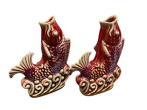 Lot 57 - A mirror pair of Shekwan sang de boeuf glazed leaping carp