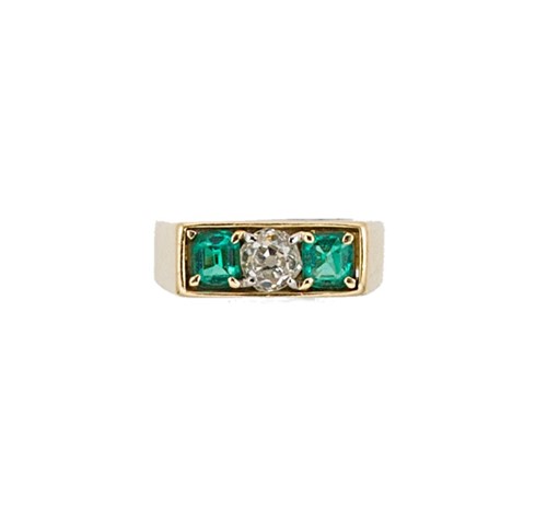 Lot 76 - An emerald and diamond three stone ring