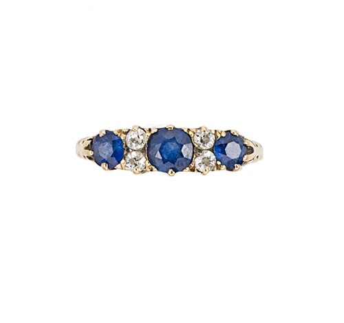 Lot 115 - A sapphire and diamond carved half hoop style ring