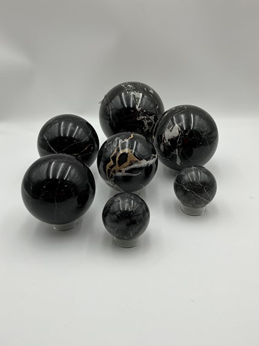 Lot 138 - A collection of seven marble balls of various...