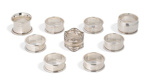 Lot 370 - A group of nine English hallmarked napkin rings