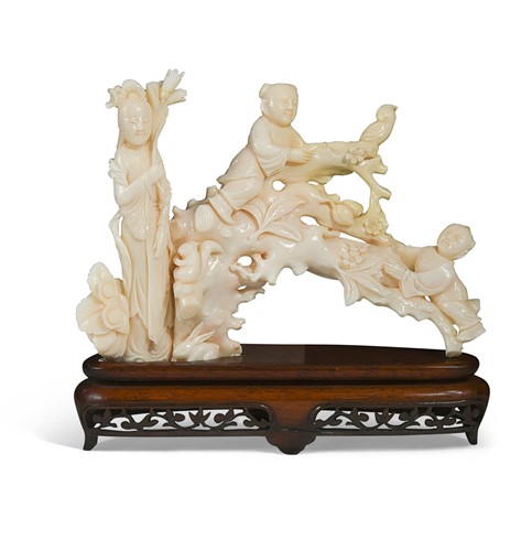 Lot 21 - A Chinese white coral one-piece figural carving