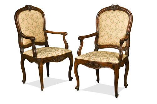 Lot 606 - A pair of Italian Rococo walnut open armchairs, 18th century