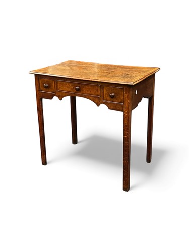 Lot 687 - A George III oak side table, the crossbanded...