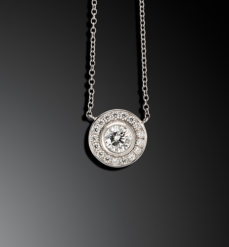 Lot 123 - A halo style diamond set necklace