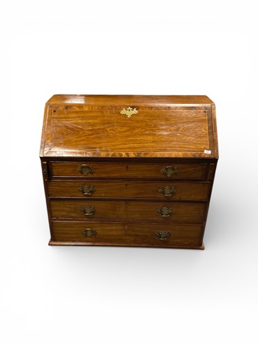 Lot 665 - A George III inlaid mahogany bureau, slope...