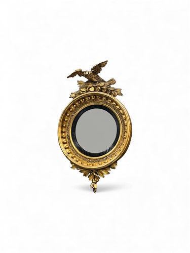 Lot 775 - A Regency gilt convex wall mirror surmounted...