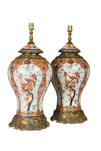 Lot 404 - A pair of Imari palette baluster vases