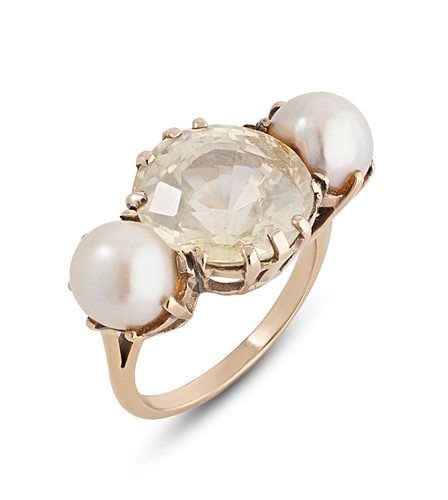 Lot 130 - A yellow sapphire and pearl three stone ring
