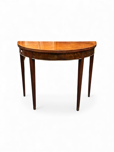 Lot 729 - A mahogany demi lune fold over tea table, 19th...