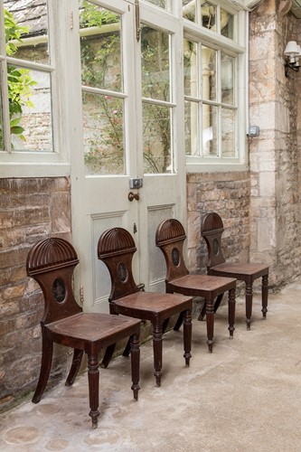 Lot 503 - A set four Regency mahogany hall chairs