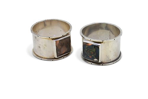Lot 174 - Guild of Handicraft, a pair of Arts & Crafts silver napkin rings