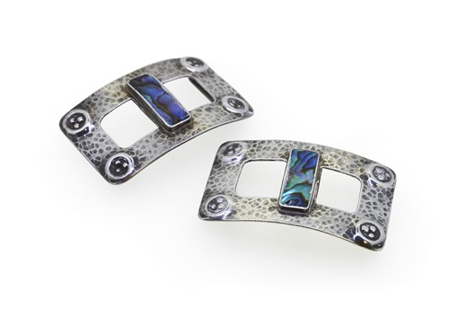 Lot 175 - In the manner of Jessie M. King, a pair of white metal and abalone buckles