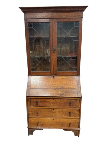 Lot 639 - An Arts & Crafts oak bureau bookcase, with...