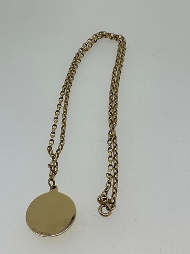 Lot 282 - A hallmarked 9ct gold disc pendant suspended...