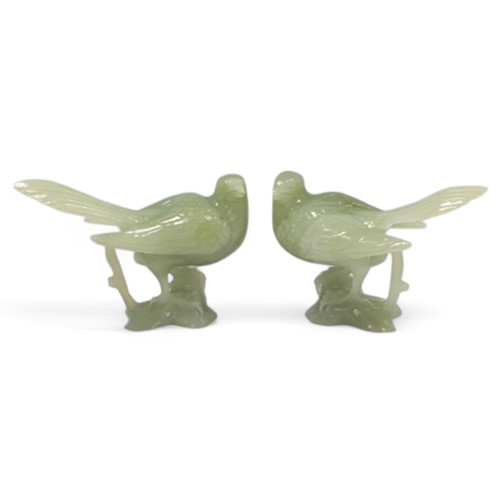 Lot 32 - A pair of Chinese light green jade long-tailed birds, 20th century