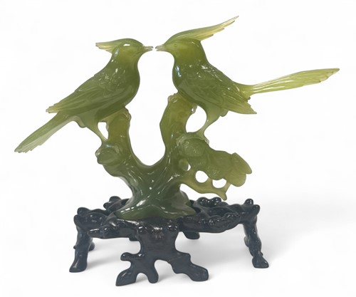 Lot 27 - A Chinese jade bird group, 20th century