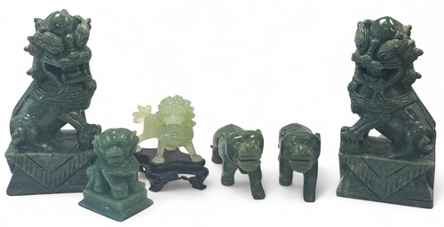 Lot 31 - A pair of Chinese mottled green jade standing tigers, 20th century