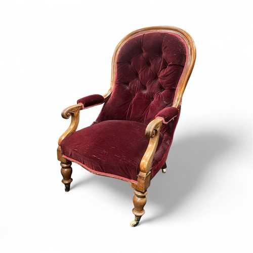 Lot 652 - A Victorian walnut button back armchair with...