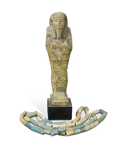 Lot 668 - An Egyptian faience shabti figure, impressed with hieroglyphics