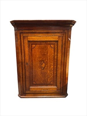 Lot 671 - A George III oak corner cupboard with shell...